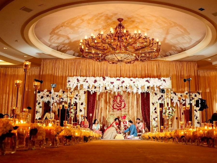 A wedding hall decorated with lights and flowers