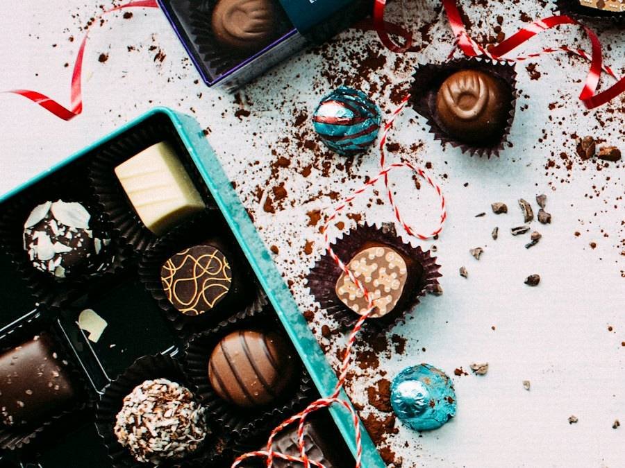 An open box of assorted chocolates tied with ribbon