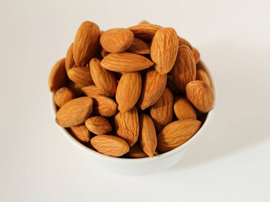A white bowl of whole almonds
