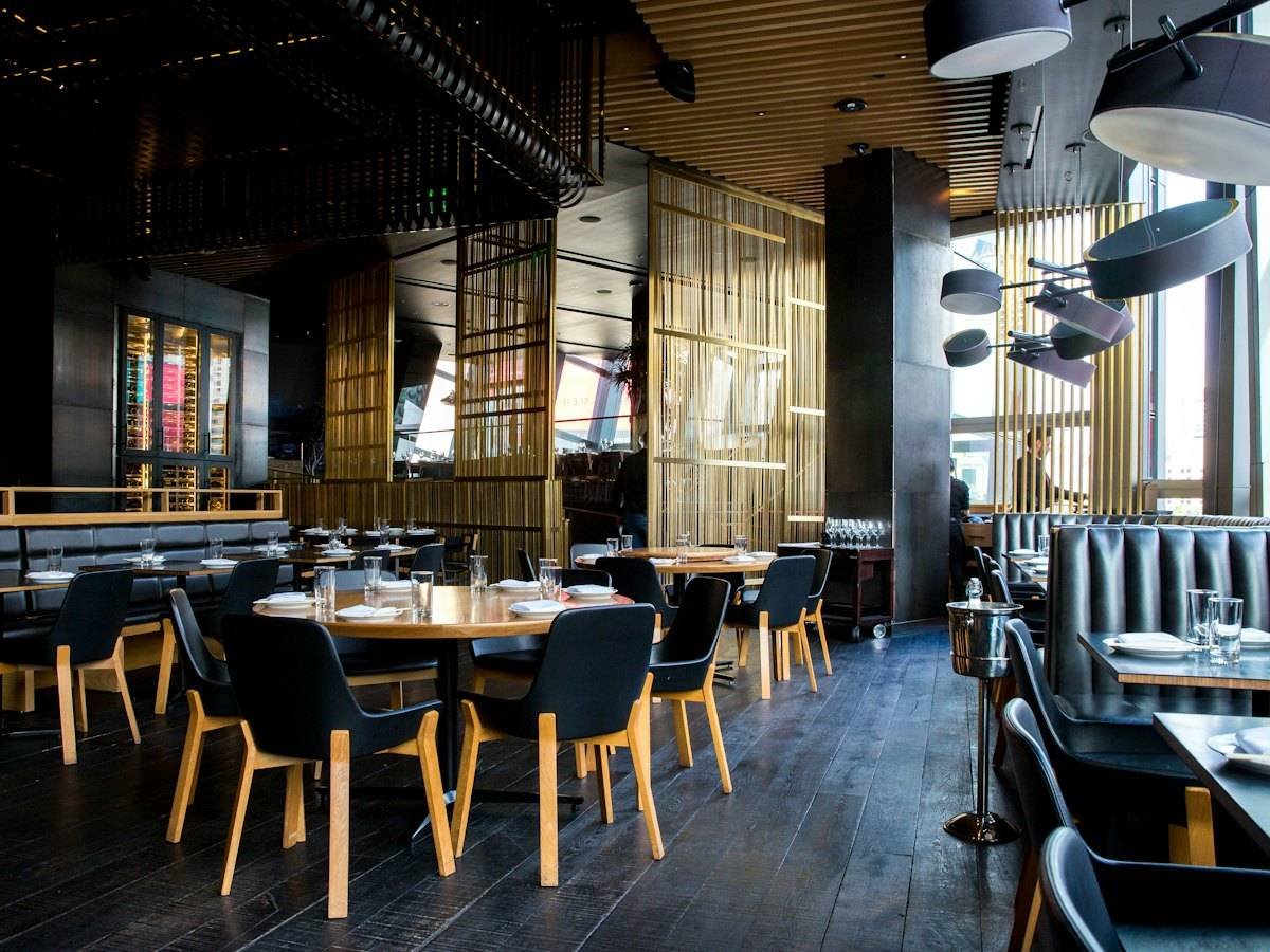 An elegant dining room with tables set for service