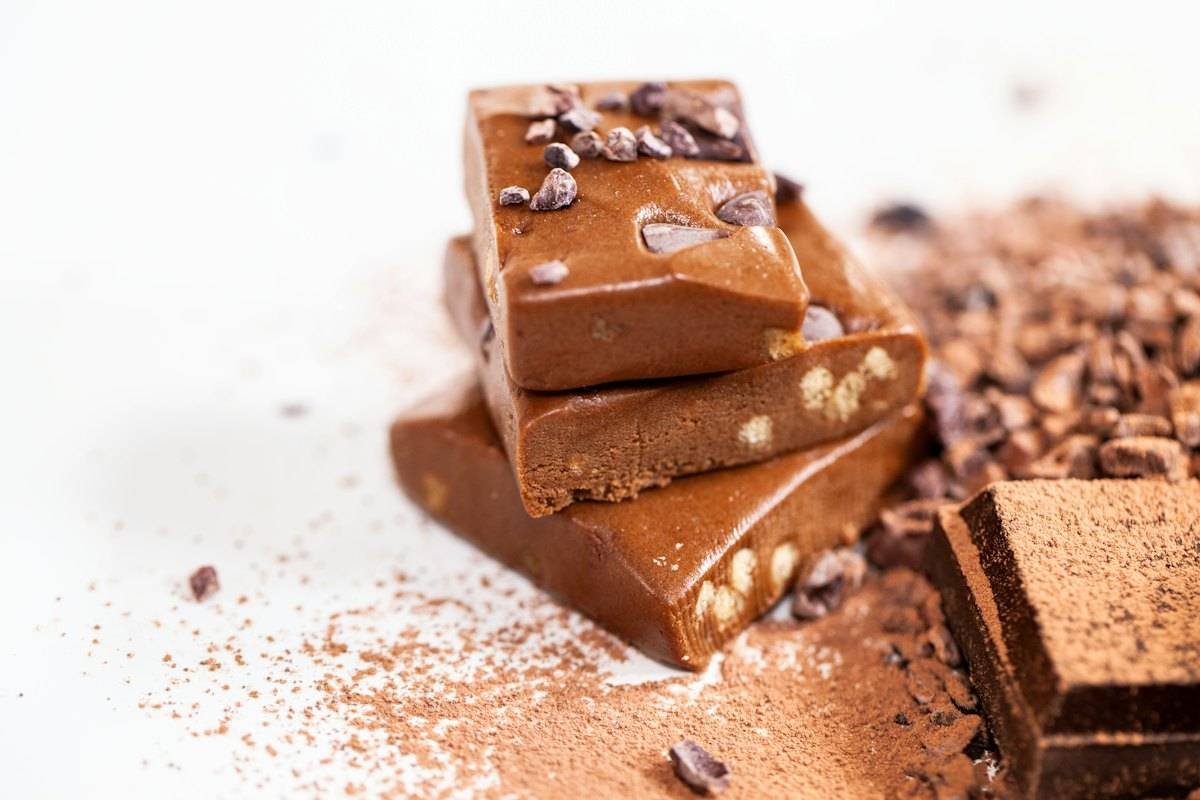 Stacked pieces of caramel chocolate fudge with nuts